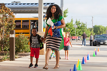 a young student walks to a pre-k 4 sa center after bus drop off
