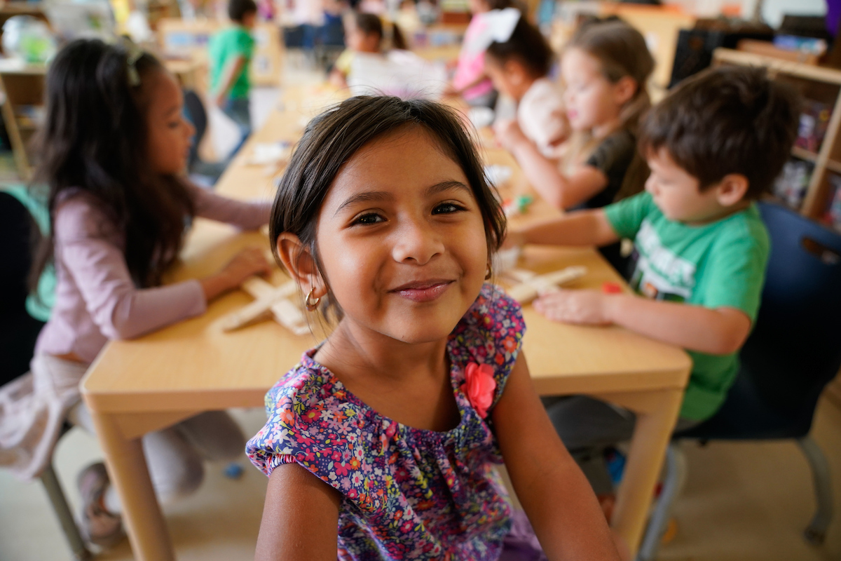 a young girl smiles into the camera