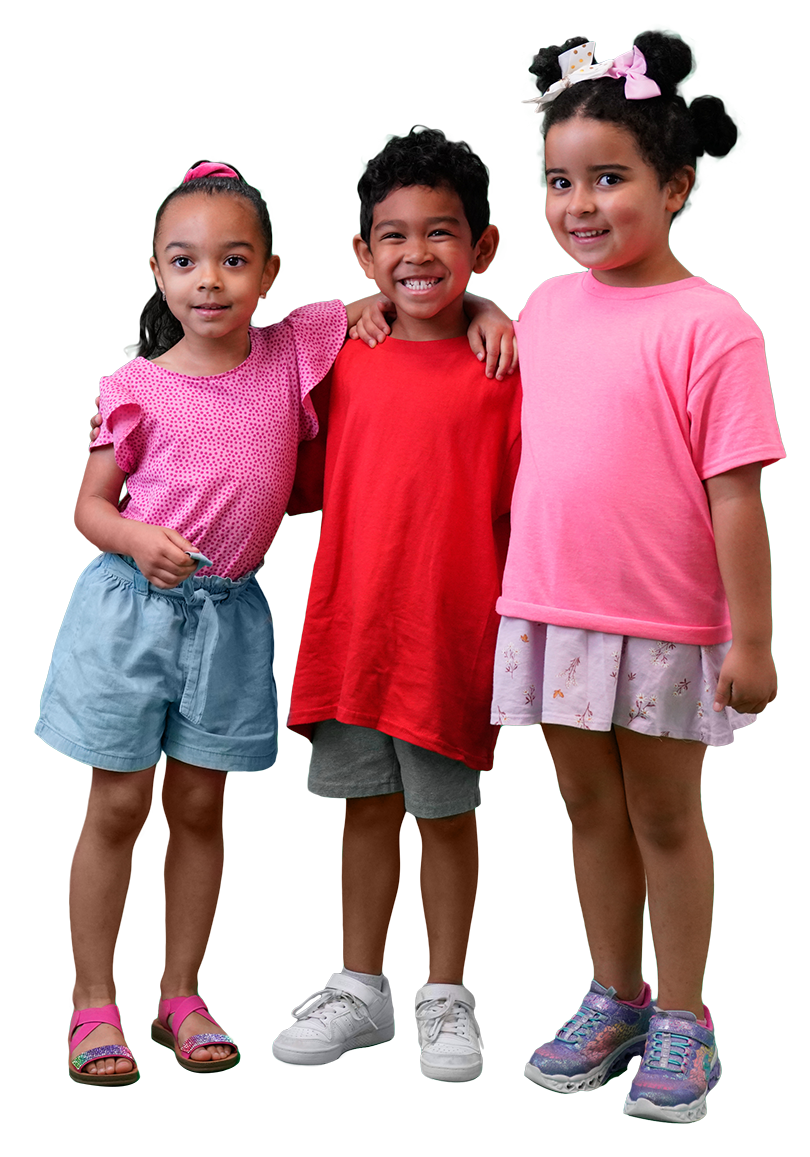 a young boy in red and two young girls in red stand together and smile
