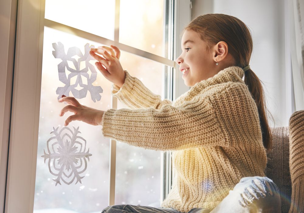 A Child makes paper snowflakes
