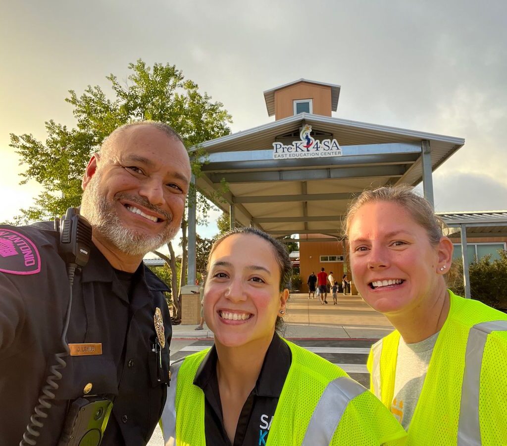 An officer and staff stop for a selfie
