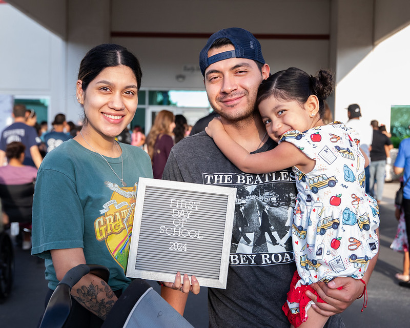 Family poses for a photo on their first day at pre-k.