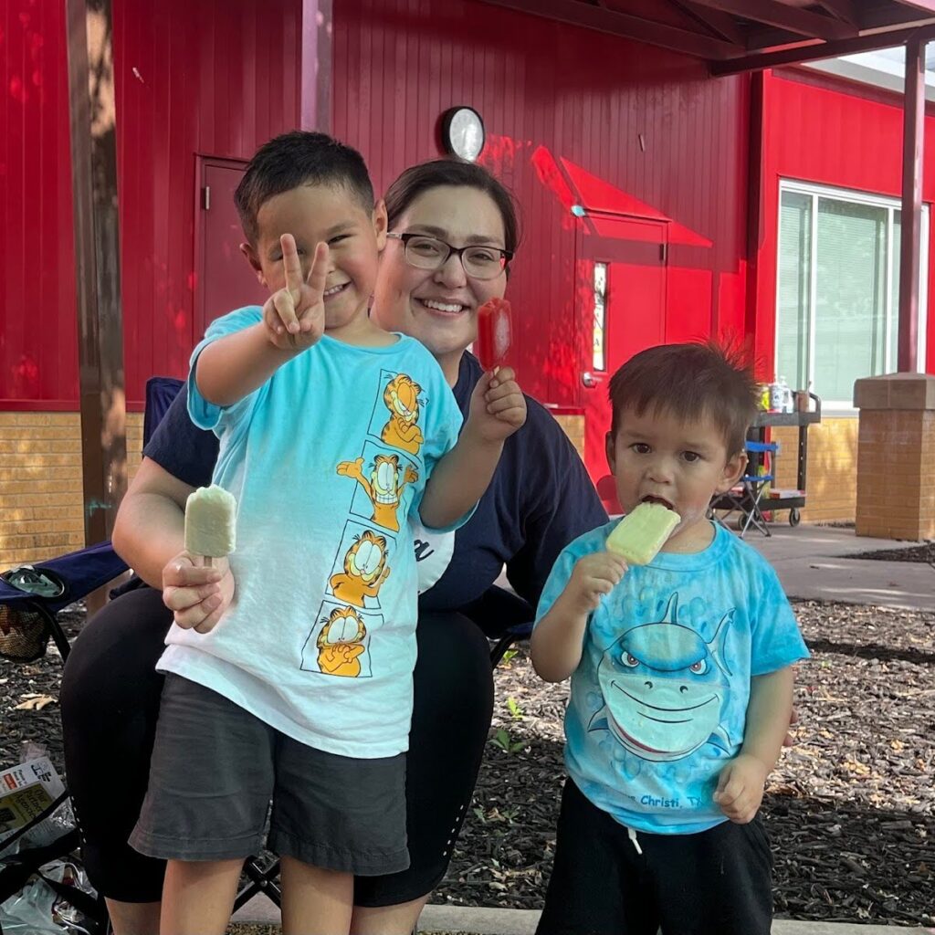 children wave at the camera and smile