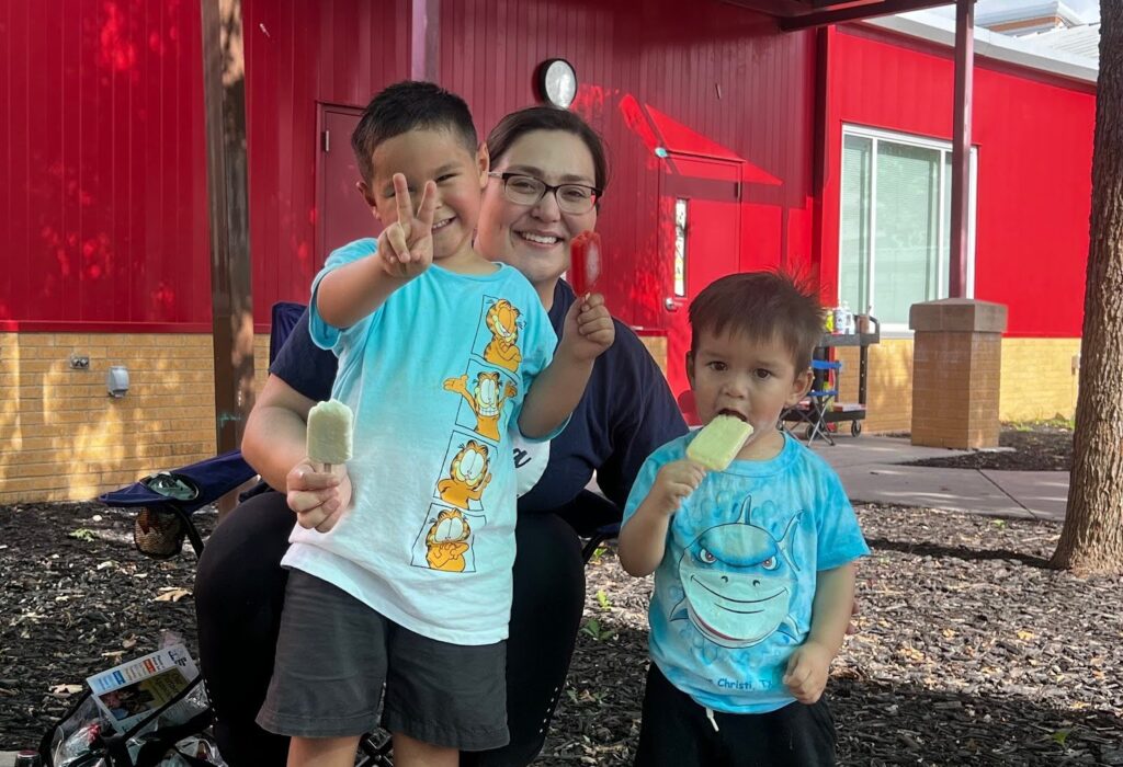 children wave at the camera and smile