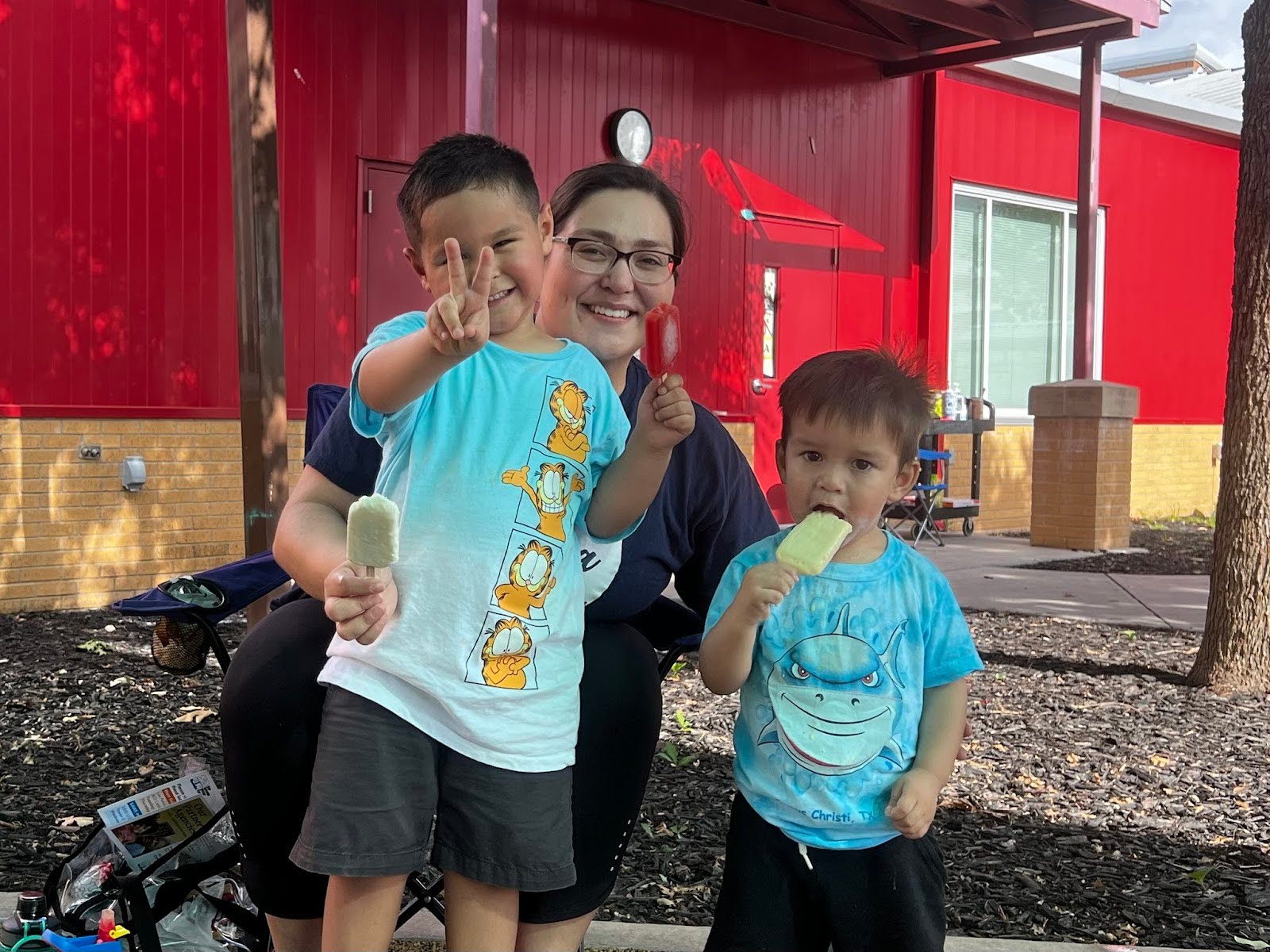 children wave at the camera and smile