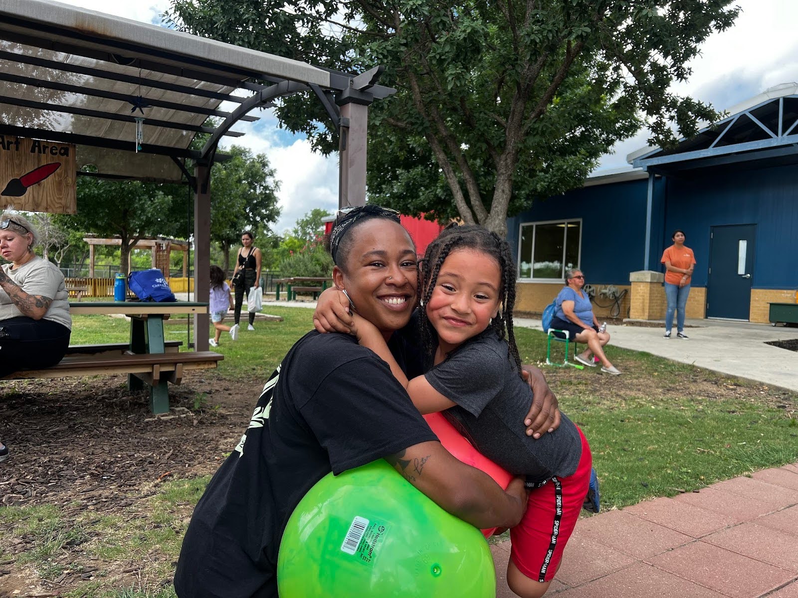 a child hugs a teacher