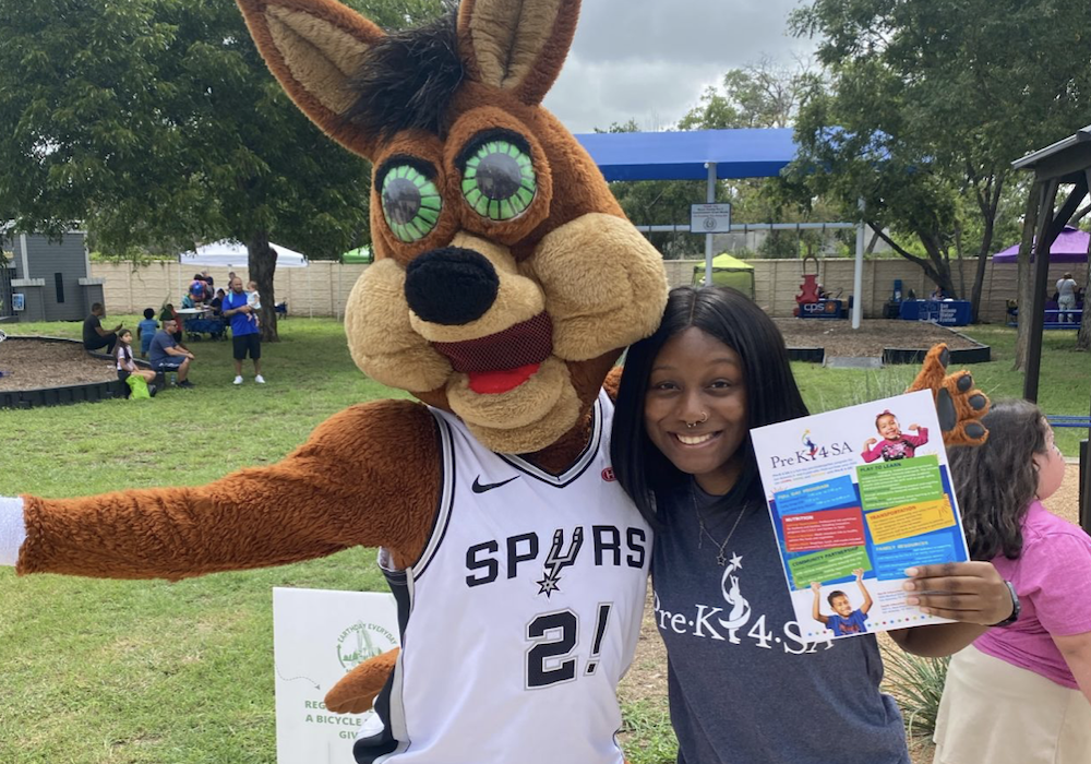 The Spurs Coyote and Pre-K 4 SA intern Camyl Delaney pose together for a photo