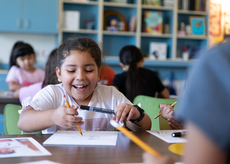 A Gardendale student draws on a piece of paper in a classroom