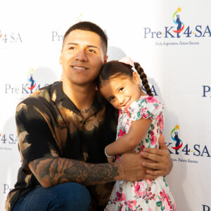 A father hugs his young daughter