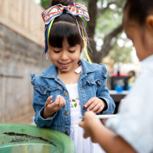 A young child explores outside