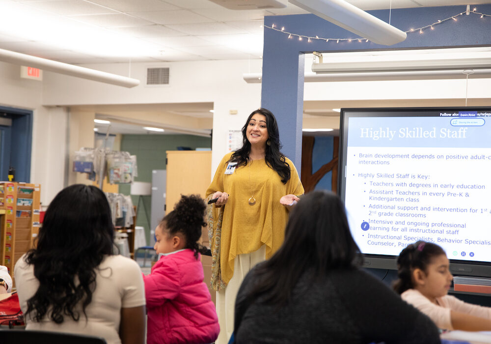 A woman giving a presentation to a group of children