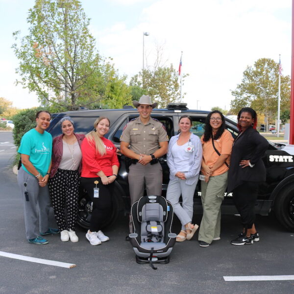 State Trooper Car Safety A group of people standing next to a police car
