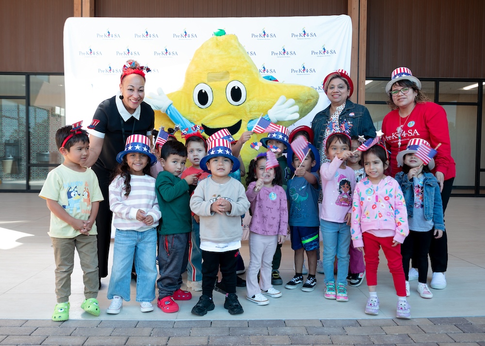 Stars mascot celebrating with diverse preschool children and teachers during patriotic event at Pre-K 4 SA in San Antonio, Texas.
