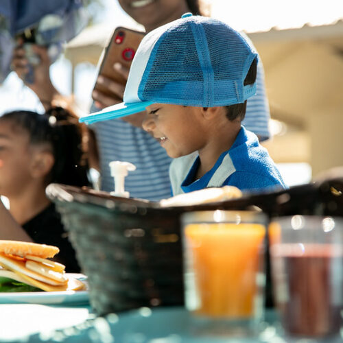 young boy sandwich snack outside