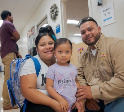 Pre-K 4 SA family visit with young girl and caregivers in a welcoming classroom environment.