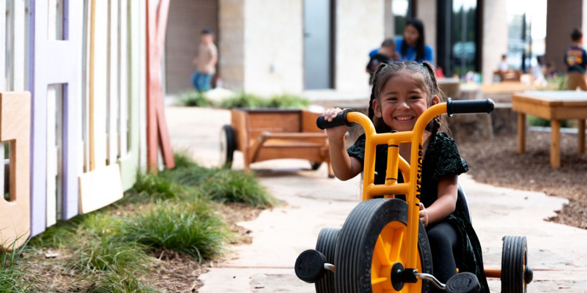 young toddler riding a bike in an outdoor area