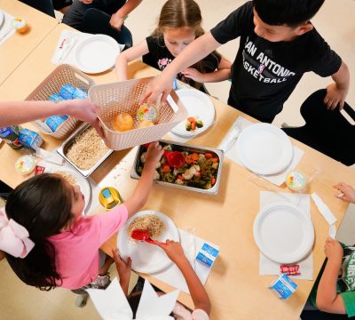 young children at a table share a family-style meal