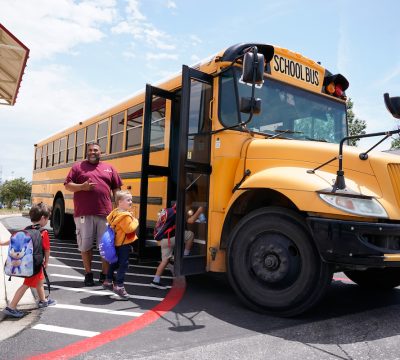 a school bus arrives to pick up children