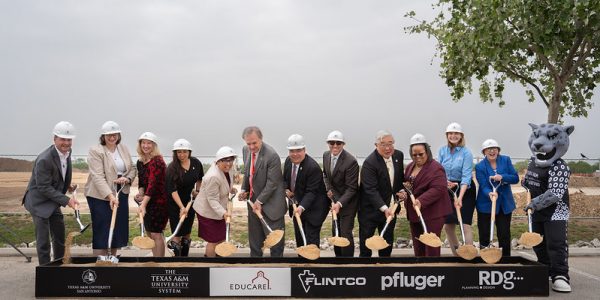 Community leaders and mascot at groundbreaking ceremony for Pre-K 4 SA school.