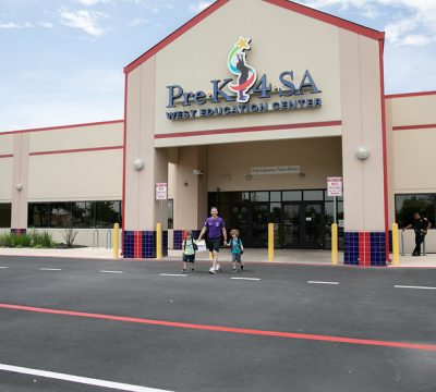 a father and sons walk out of the pre-k 4 sa west education center
